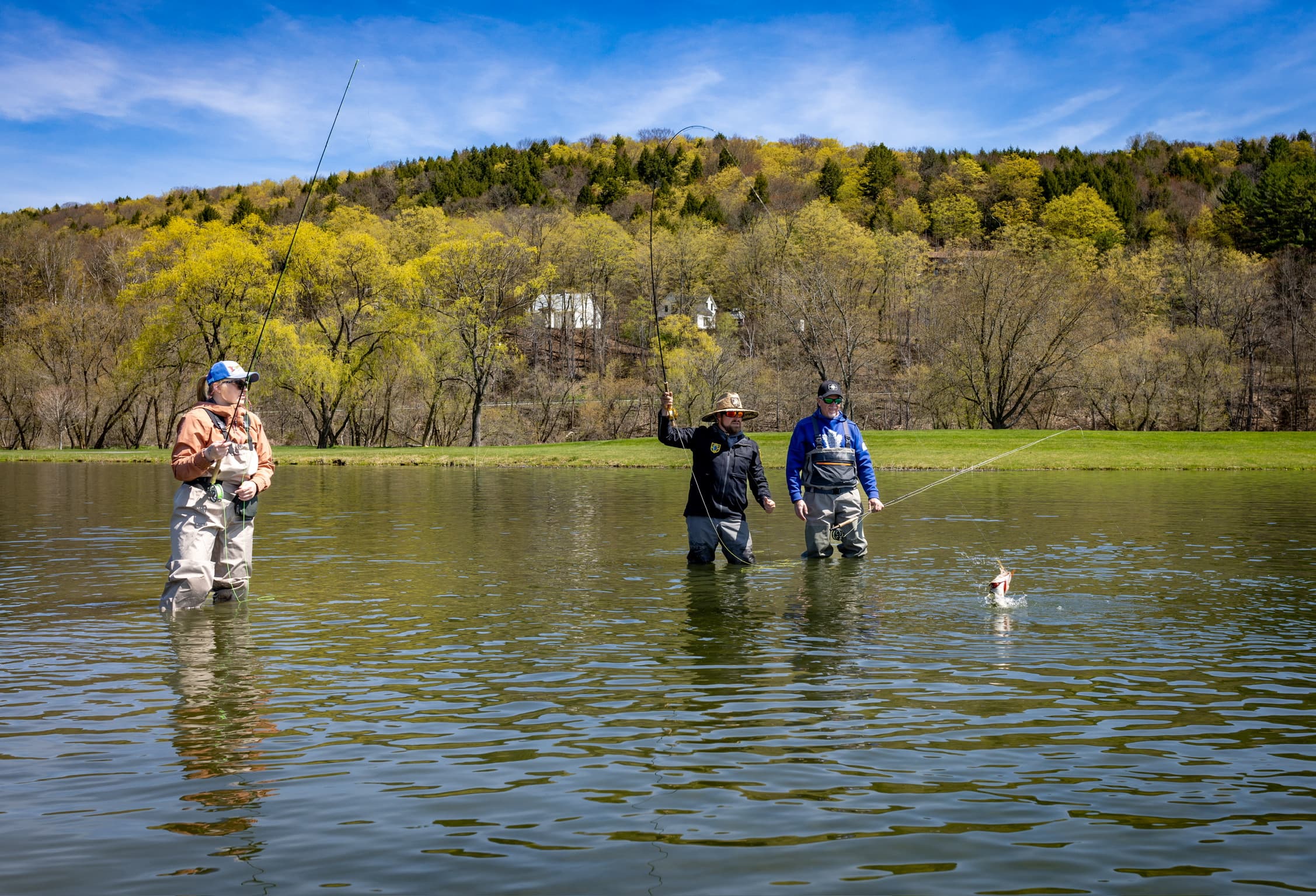 Fly fisherman in boat displaying trophy northern pike