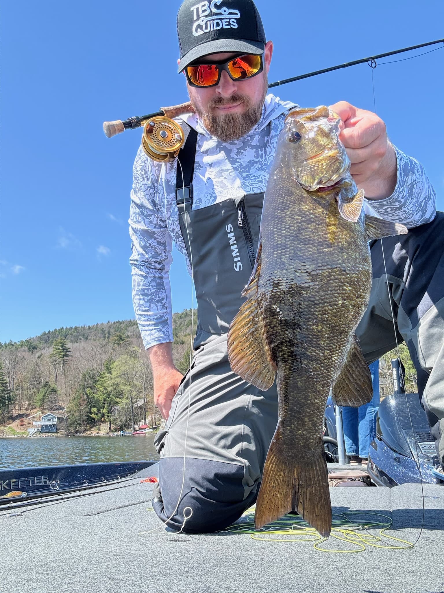 Trophy bass caught on fly tackle being released back to water