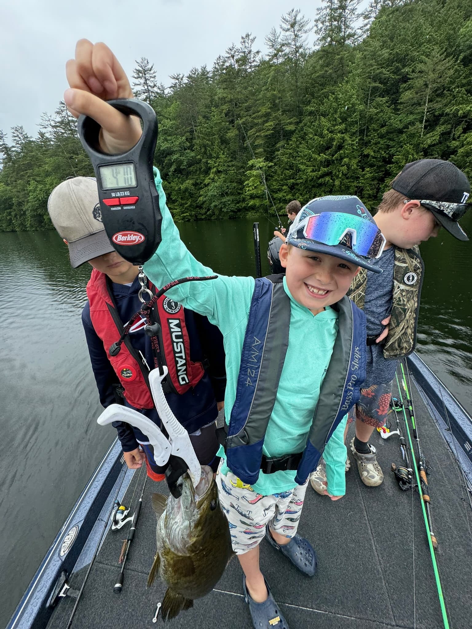 Group of young anglers proudly displaying their catch