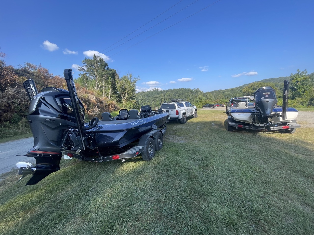 bass boat attached to truck on grass