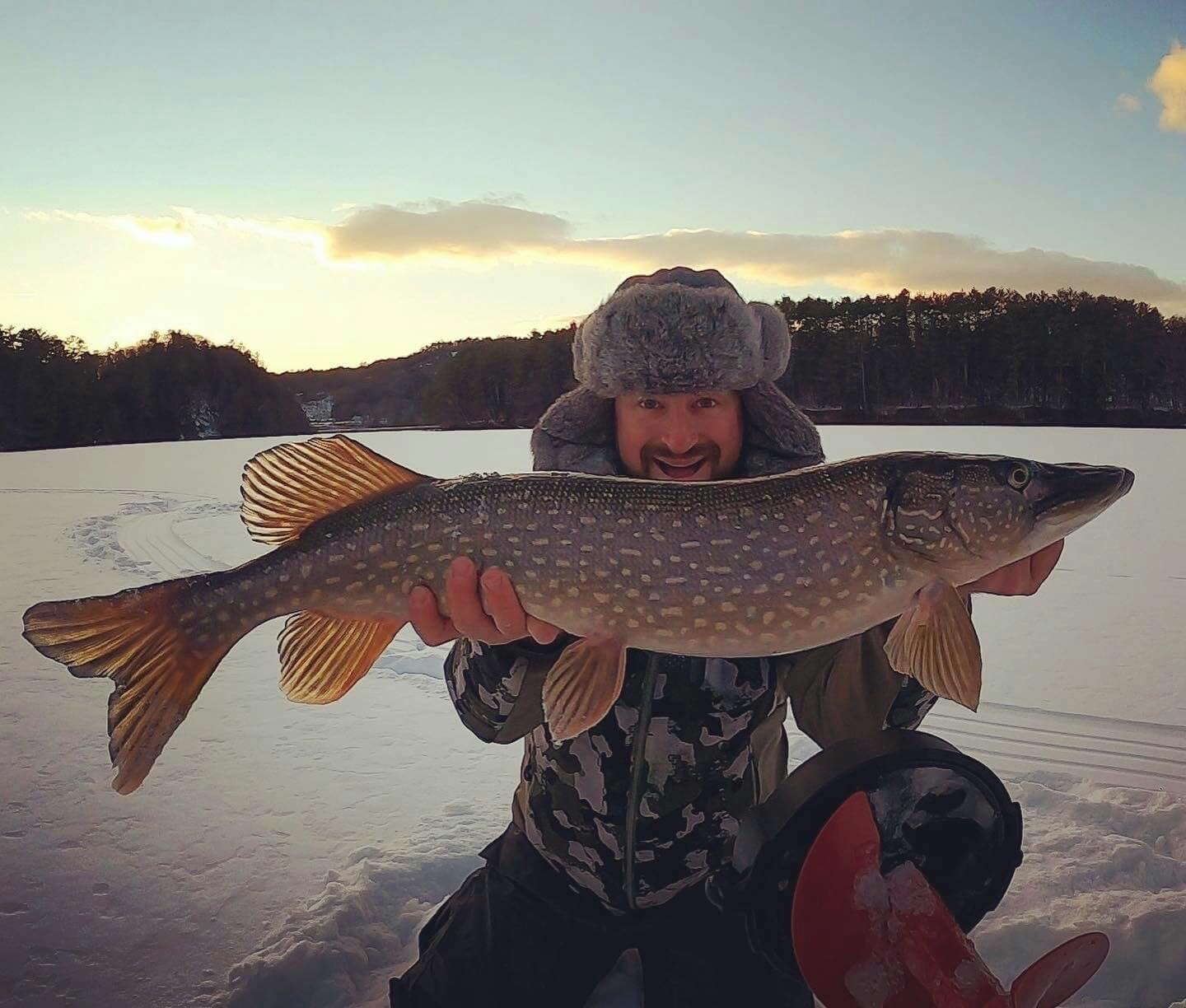 Mike Blatt holding fish on frozen lake